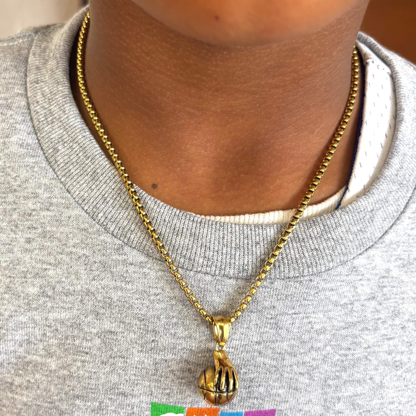 Hand Palming Basketball Pendant on 14k gold plated chain necklace worn on neck