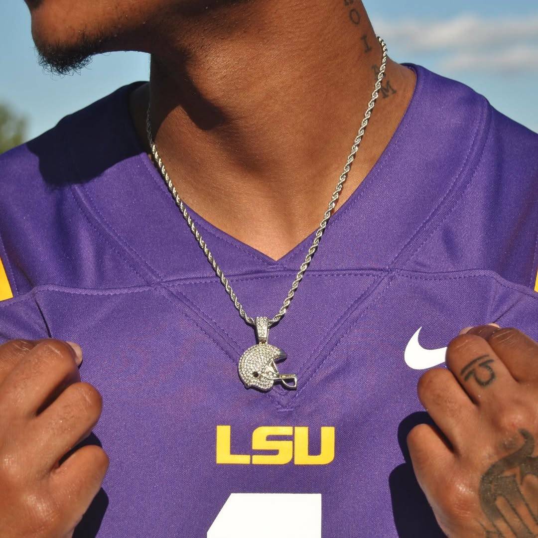 Studded football helmet pendant necklace worn by person in purple LSU jersey with 3mm rope chain and lobster clasp