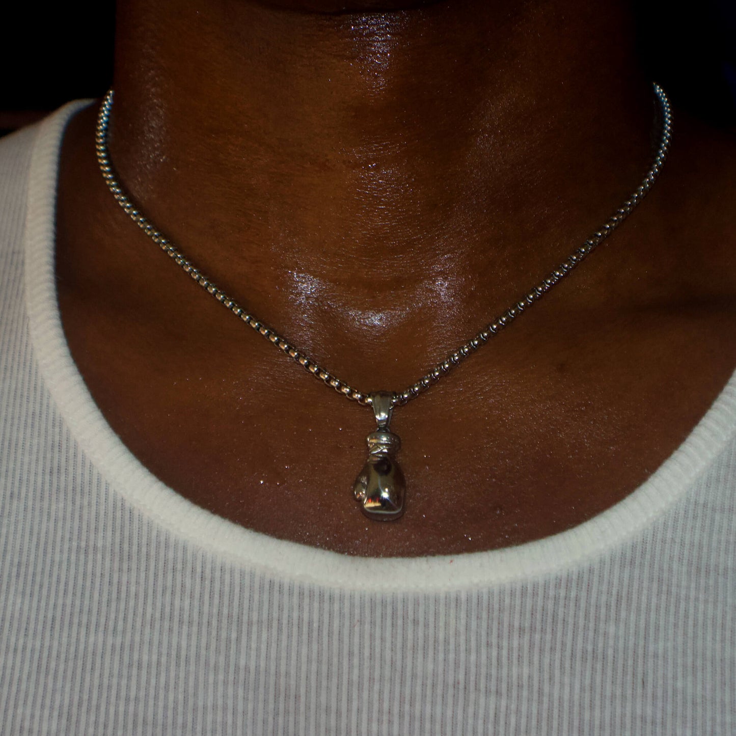 Silver boxing glove pendant on 3mm box chain necklace worn on neck
