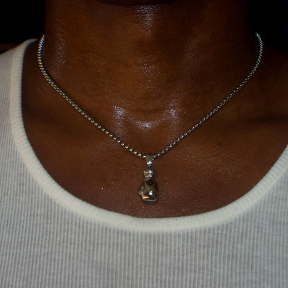 Silver boxing glove pendant on 3mm box chain necklace worn on neck