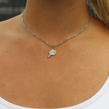 Silver pickleball paddle pendant necklace on a woman’s neck with 2.5mm link chain and lobster clasp
