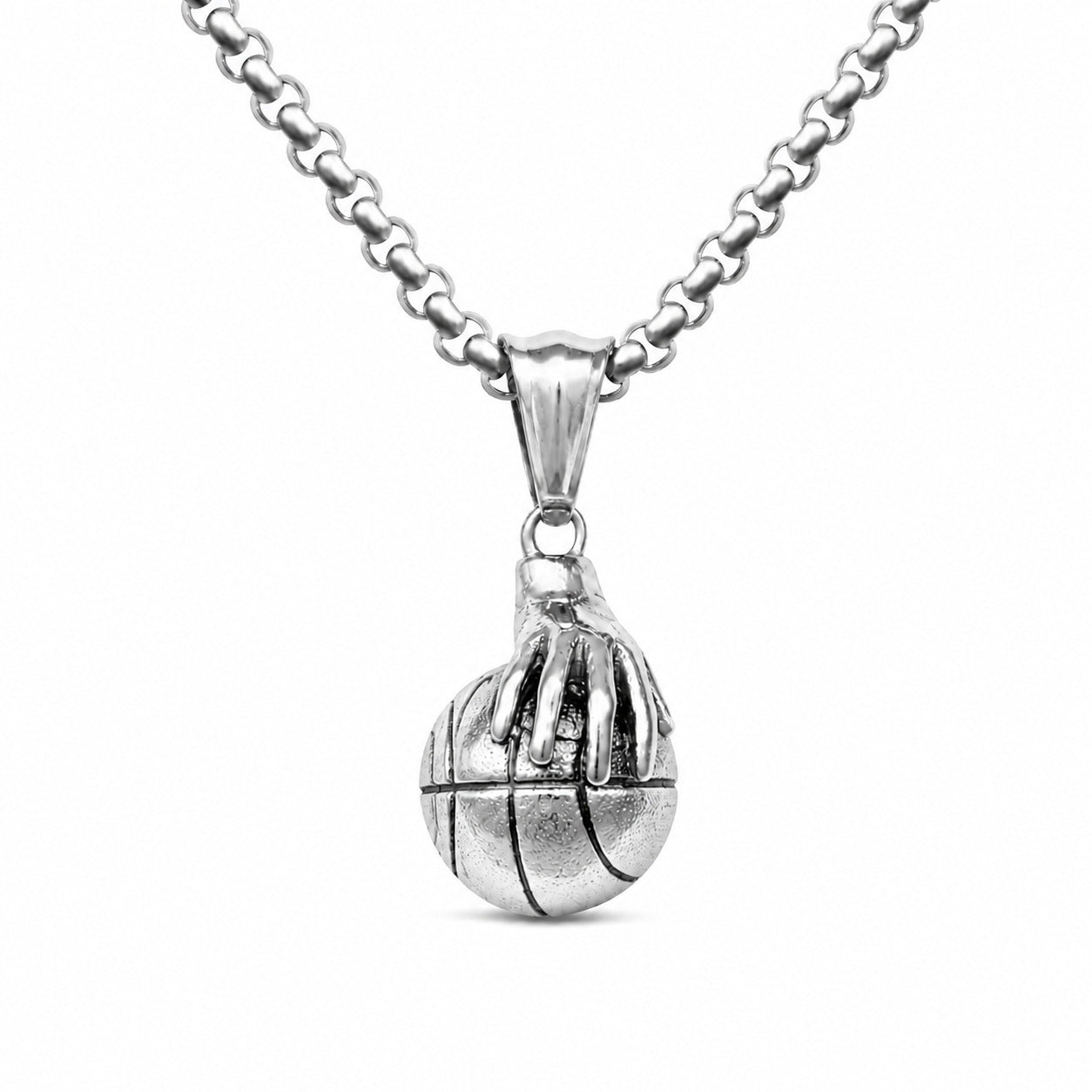 A silver pendant necklace featuring a basketball design with a hand gripping it, suspended from a matching silver chain against a plain white background.