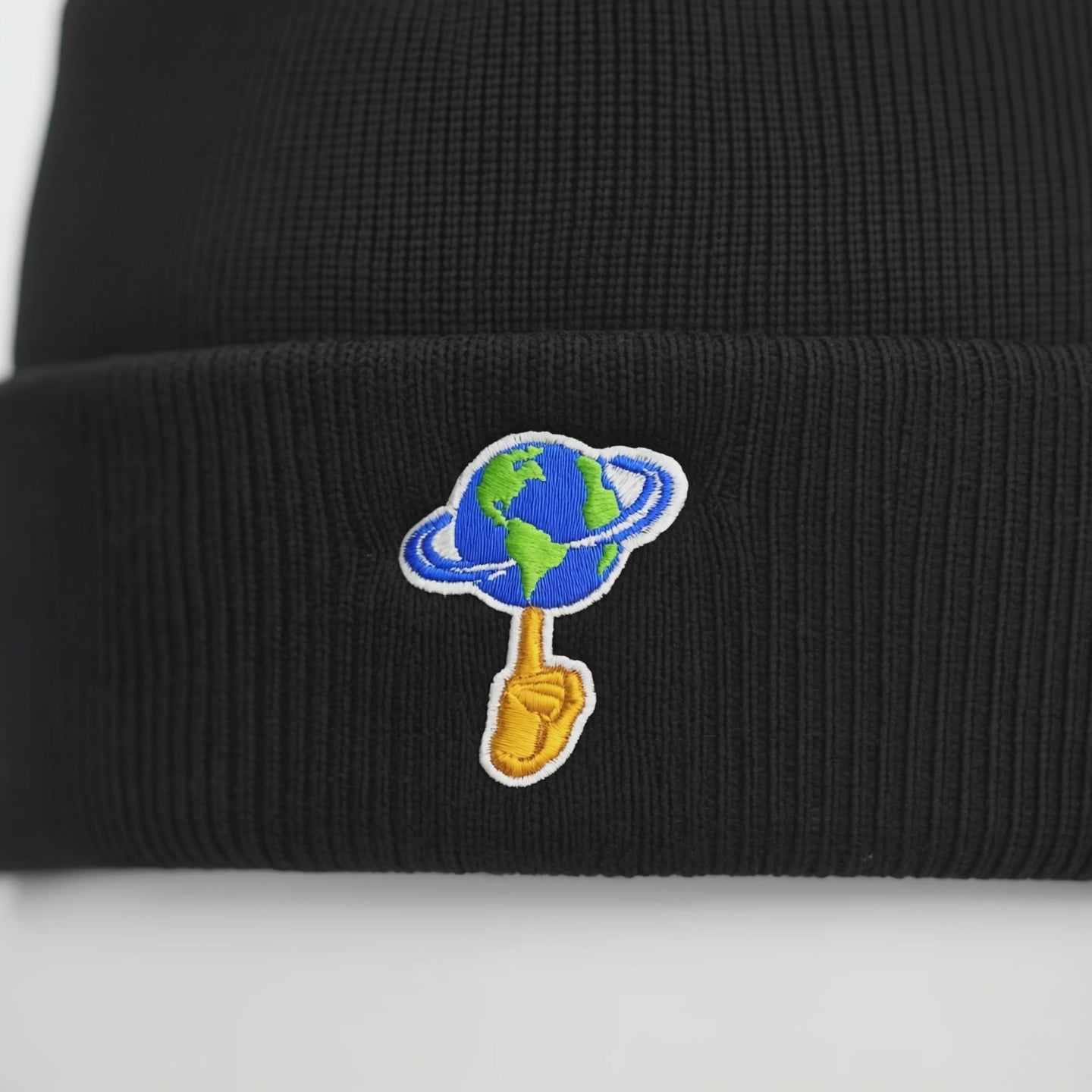 Black beanie with 'World is Yours' text on a white background